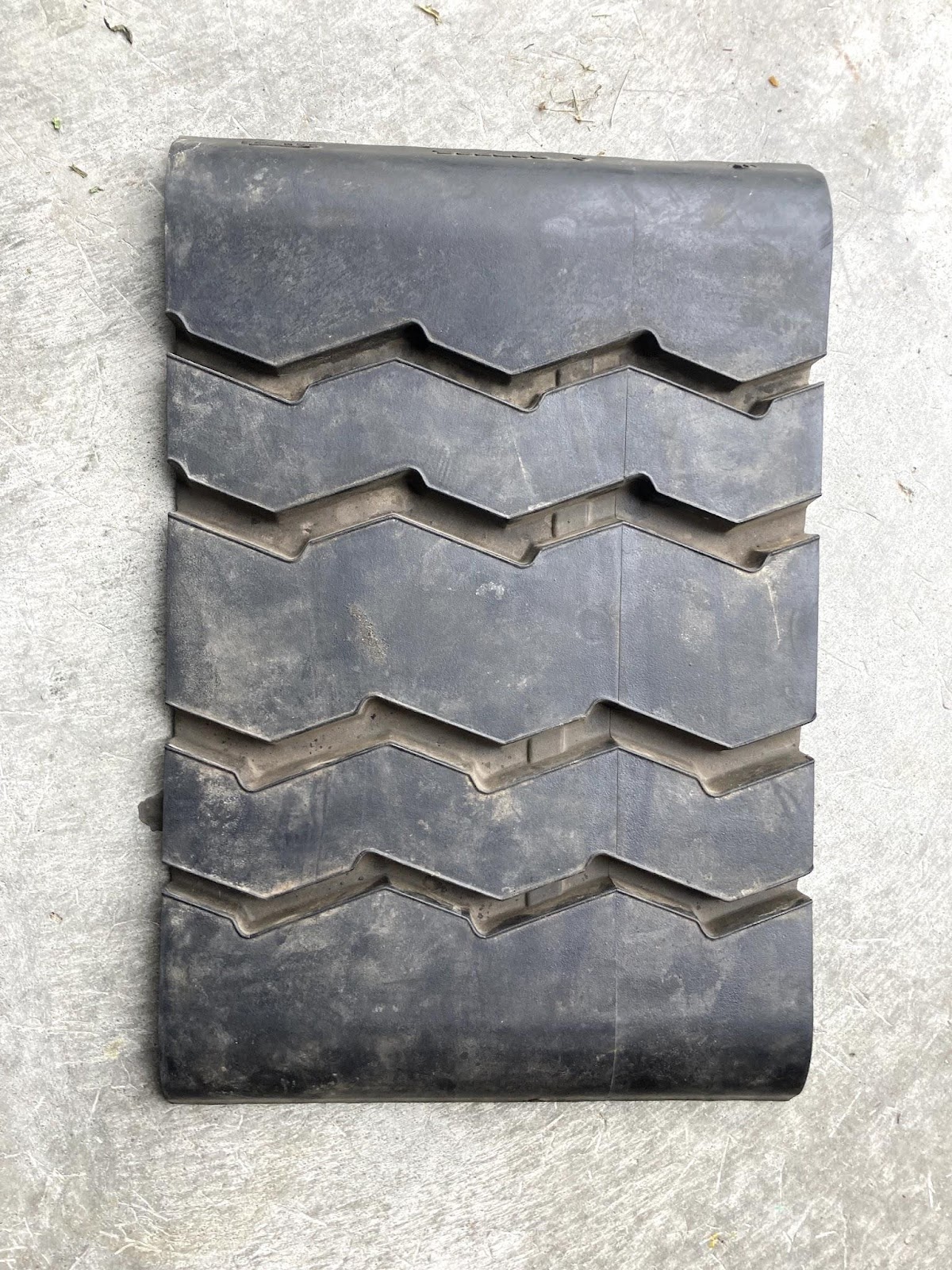 This is a small 12-inch cut of a "cap retread". This picture shows the outer layer of this rubber piece. 